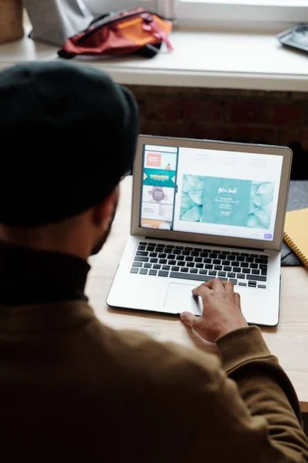 hero-img A person using a laptop to browse stock photo websites. Freelancing work in a cozy setting.